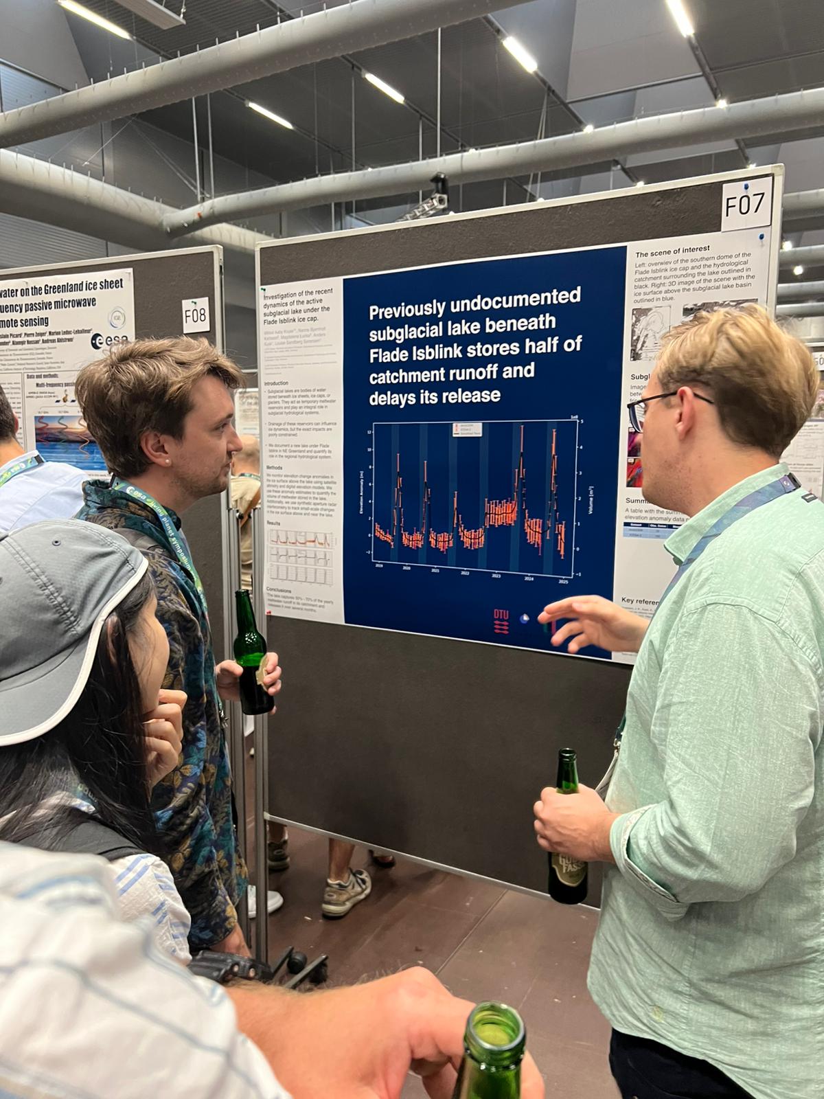 Ph.d.-student Mikkel Aaby Kruse (right) is presenting poster to two conference participants during the poster session. 